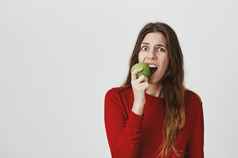 Bright red apple symbolizing the connection between oral health and nutritious eating