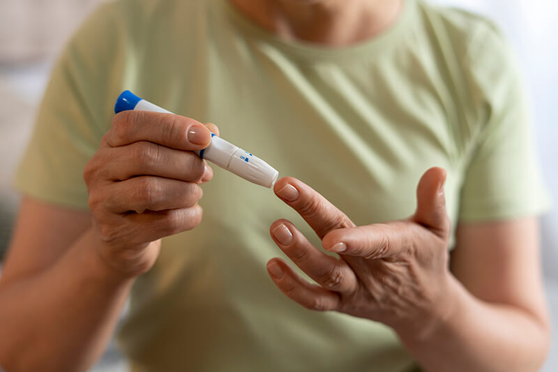 Woman checking blood sugar levels with a glucose meter