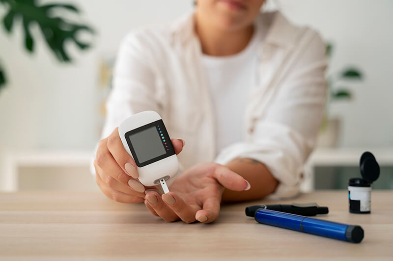 A person testing blood sugar levels with a glucometer